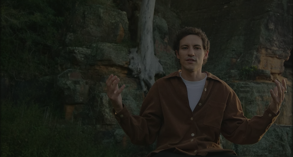 A meditation teacher seated outdoors
